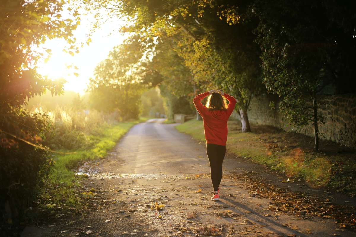 Women breathing in branch covered pathway 